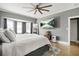 Spacious main bedroom featuring a large bed, hardwood floors, gray walls, and natural light at 4900 College St, Union City, GA 30291
