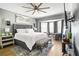 Spacious main bedroom with a large bed, gray walls, natural light, and hardwood floors at 4900 College St, Union City, GA 30291