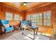 Office space with rustic wood walls, comfortable seating, and a view to the outside at 4900 College St, Union City, GA 30291