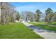 Scenic view of a home with a long driveway and lush green lawn at 4900 College St, Union City, GA 30291