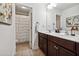 Bathroom features a double vanity sink and a shower at 5860 Bluff Heights Drive, Cumming, GA 30040