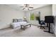 This bedroom features soft carpet, a large window with green views, and a ceiling fan for added comfort at 5860 Bluff Heights Drive, Cumming, GA 30040