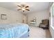Cozy bedroom featuring soft carpet, a ceiling fan, a neutral color palette, and a comfortable sitting area at 5860 Bluff Heights Drive, Cumming, GA 30040