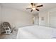 Bedroom with ceiling fan, rocking chair, and lots of natural light at 5860 Bluff Heights Drive, Cumming, GA 30040