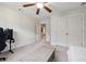 This bedroom boasts soft carpet, an overhead ceiling fan, and plenty of closet storage space at 5860 Bluff Heights Drive, Cumming, GA 30040