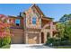 Beautiful two-story home with brick and stone exterior, two-car garage and well manicured landscaping at 5860 Bluff Heights Drive, Cumming, GA 30040