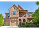 Beautiful two-story home with brick and stone exterior, two-car garage and well manicured landscaping at 5860 Bluff Heights Drive, Cumming, GA 30040