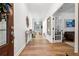 Bright foyer with hardwood floors, white walls, and decorative mirror and table at 5860 Bluff Heights Drive, Cumming, GA 30040