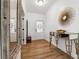 Bright foyer with hardwood floors, white walls, and decorative mirror and table at 5860 Bluff Heights Drive, Cumming, GA 30040