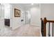 Bright hallway with natural light showcasing access to a bathroom, bedroom, and staircase at 5860 Bluff Heights Drive, Cumming, GA 30040