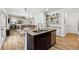 Spacious kitchen with granite island, hardwood floors, and stainless steel appliances at 5860 Bluff Heights Drive, Cumming, GA 30040