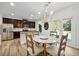 Sunny kitchen with stainless appliances, an eat-in area, and backyard access at 5860 Bluff Heights Drive, Cumming, GA 30040