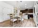 Charming eat-in kitchen featuring stainless appliances, hardwood floors, and modern lighting at 5860 Bluff Heights Drive, Cumming, GA 30040