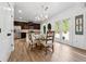 Eat-in kitchen featuring stainless steel appliances, hardwood floors, and backyard access at 5860 Bluff Heights Drive, Cumming, GA 30040