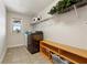 Functional laundry room with modern appliances, shelving, and a bright window at 5860 Bluff Heights Drive, Cumming, GA 30040