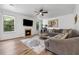 Inviting living room with a fireplace, large windows, and a comfortable sectional sofa at 5860 Bluff Heights Drive, Cumming, GA 30040