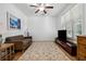 Cozy living room features large window, ceiling fan, plush rug, and comfortable seating at 5860 Bluff Heights Drive, Cumming, GA 30040