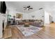 Cozy living room features a decorative fireplace, ceiling fan, and comfortable seating at 5860 Bluff Heights Drive, Cumming, GA 30040