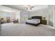 Spacious main bedroom with a ceiling fan, two beds, and large windows overlooking landscaped yard at 5860 Bluff Heights Drive, Cumming, GA 30040