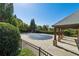 Community pool with a covered pavilion and ample seating, surrounded by well-maintained landscaping at 5860 Bluff Heights Drive, Cumming, GA 30040