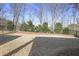 Large, flat backyard features a black metal fence and mature trees creating a private outdoor space at 1011 Stillington Way, Kennesaw, GA 30152