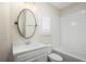 Cozy bathroom with a white vanity, stylish mirror, and a tub with white subway tile at 1011 Stillington Way, Kennesaw, GA 30152