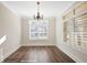 Bright dining room with large windows, shutters and stylish hardwood floors at 1011 Stillington Way, Kennesaw, GA 30152