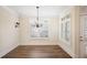 Dining room with hardwood floors, white trim, plantation shutters, and chandelier at 1011 Stillington Way, Kennesaw, GA 30152