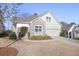 Charming home featuring brick accents, a well-manicured lawn, and an attached garage at 1011 Stillington Way, Kennesaw, GA 30152