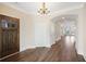 Inviting foyer with dark wood door that opens to the main living area and hardwood floors at 1011 Stillington Way, Kennesaw, GA 30152