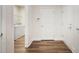 Hallway with wood-look floors and views into laundry room at 1011 Stillington Way, Kennesaw, GA 30152