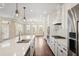 Modern kitchen featuring a large island, stainless steel appliances, and open to the living area at 1011 Stillington Way, Kennesaw, GA 30152