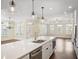 Bright kitchen with a large center island, stainless steel appliances, and hardwood flooring at 1011 Stillington Way, Kennesaw, GA 30152