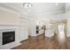 Open-concept living space features a fireplace, white cabinetry, and a kitchen with a center island at 1011 Stillington Way, Kennesaw, GA 30152