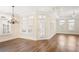 Living room bathed in natural light features hardwood floors, recessed lighting, and white shutters at 1011 Stillington Way, Kennesaw, GA 30152