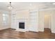 Bright living room featuring a fireplace, built-in shelving, and hardwood floors at 1011 Stillington Way, Kennesaw, GA 30152