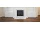 Fireplace with white mantle and built-in shelving in a well-lit living room with hardwood floors at 1011 Stillington Way, Kennesaw, GA 30152