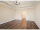Empty living room with hardwood floors, trim, tray ceilings, and neutral paint at 1011 Stillington Way, Kennesaw, GA 30152