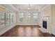 Spacious living room with hardwood floors, natural light, and a fireplace with a white mantel at 1011 Stillington Way, Kennesaw, GA 30152
