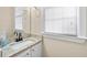 Bathroom vanity featuring granite countertops, a large mirror, and natural light at 1811 Lake Cove Sw Dr, Atlanta, GA 30331
