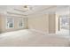 Large bedroom with tray ceiling, neutral carpeting, and windows for plenty of natural light at 1811 Lake Cove Sw Dr, Atlanta, GA 30331