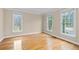Bright and airy bedroom with hardwood flooring and large windows overlooking the yard at 1811 Lake Cove Sw Dr, Atlanta, GA 30331