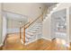 Welcoming foyer featuring hardwood floors, staircase, and views into the living spaces at 1811 Lake Cove Sw Dr, Atlanta, GA 30331