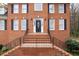 Close-up of front door, stairs, and brick facade. Beautiful black door with decorative window at 1811 Lake Cove Sw Dr, Atlanta, GA 30331