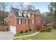 Side angle of brick home with an attached garage and beautifully maintained yard at 1811 Lake Cove Sw Dr, Atlanta, GA 30331
