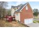 Two-story home with brick and siding, a two-car garage, and a wooden deck at 1811 Lake Cove Sw Dr, Atlanta, GA 30331