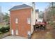 Rear view of home featuring brick facade and wooden deck at 1811 Lake Cove Sw Dr, Atlanta, GA 30331