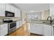 Well-lit kitchen featuring stainless steel appliances, granite countertops, and hardwood floors at 1811 Lake Cove Sw Dr, Atlanta, GA 30331