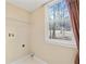 Laundry room featuring utility connections, shelving, and a window overlooking the yard at 1811 Lake Cove Sw Dr, Atlanta, GA 30331