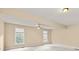 Spacious main bedroom with carpet, large windows, and a ceiling fan at 1811 Lake Cove Sw Dr, Atlanta, GA 30331